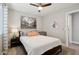 Inviting bedroom with a large window, overhead lighting, and a decorative mirror in a comforting setting at 1057 W Laurel Ave, Gilbert, AZ 85233