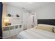 Comfortable bedroom with ample natural light, complemented by neutral tones and modern decorative shelving at 1057 W Laurel Ave, Gilbert, AZ 85233