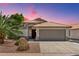 Charming single-story home featuring desert landscaping, a tile roof, and a spacious two-car garage at 1057 W Laurel Ave, Gilbert, AZ 85233