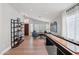 Spacious, brightly lit game room featuring a shuffleboard table and modern decor and open to the living space at 1057 W Laurel Ave, Gilbert, AZ 85233