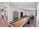 Spacious, brightly lit game room featuring a shuffleboard table and modern decor at 1057 W Laurel Ave, Gilbert, AZ 85233