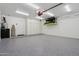 Spacious garage with epoxy flooring, built-in storage cabinets, and ample space for vehicles and storage at 1057 W Laurel Ave, Gilbert, AZ 85233