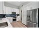 Bright kitchen featuring stainless steel appliances, white cabinets, and ample storage at 1057 W Laurel Ave, Gilbert, AZ 85233