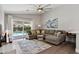 Bright living room with sliding doors leading to an outdoor pool and lounge area at 1057 W Laurel Ave, Gilbert, AZ 85233