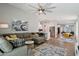 Open-concept living space with a comfortable sofa and seamless flow between living, dining, and kitchen areas at 1057 W Laurel Ave, Gilbert, AZ 85233