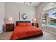 Serene main bedroom with modern decor, large window, and views of the outdoor pool area at 1057 W Laurel Ave, Gilbert, AZ 85233