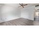 Bedroom with wood-look flooring, a ceiling fan, and closet at 11149 W Palm Ridge Dr, Sun City, AZ 85351