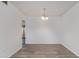 Clean, empty dining room with stylish flooring, light fixture, and doorway access at 11149 W Palm Ridge Dr, Sun City, AZ 85351