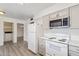 Kitchen with stainless steel microwave, stove, and bright lighting at 11149 W Palm Ridge Dr, Sun City, AZ 85351