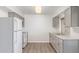 Functional kitchen features white appliances, light gray cabinets, and sleek countertop at 11149 W Palm Ridge Dr, Sun City, AZ 85351