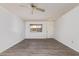 Bright living room with wood-look flooring, a window and a ceiling fan at 11149 W Palm Ridge Dr, Sun City, AZ 85351