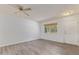 Bright living room featuring wood-look flooring, a window with blinds, and a ceiling fan at 11149 W Palm Ridge Dr, Sun City, AZ 85351