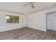 Bright living room featuring updated flooring and a window view at 11149 W Palm Ridge Dr, Sun City, AZ 85351