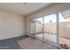 Inviting living room featuring sliding glass doors to backyard, and neutral carpet at 11149 W Palm Ridge Dr, Sun City, AZ 85351