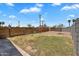 Expansive backyard with wood and block fence, offering privacy and a partially green, partially graveled space for versatile use at 1306 E Fillmore St, Phoenix, AZ 85006