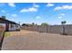 Wide backyard with a block wall, wooden fence, and desert landscaping provides a private outdoor space at 1306 E Fillmore St, Phoenix, AZ 85006
