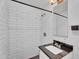 Bright bathroom featuring white subway tiles, shower, and stylish fixtures at 1306 E Fillmore St, Phoenix, AZ 85006