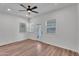 Bright bedroom with wood-look floors, white walls, ceiling fan and windows at 1306 E Fillmore St, Phoenix, AZ 85006