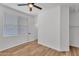 Bedroom with ceiling fan, window for natural light, and wood laminate flooring at 1306 E Fillmore St, Phoenix, AZ 85006