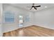 Bright bedroom with wood-look floors, white walls, ceiling fan and a glass door leading outside at 1306 E Fillmore St, Phoenix, AZ 85006