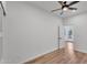 Bedroom with wood-look floors, ceiling fan and view into hall and back yard at 1306 E Fillmore St, Phoenix, AZ 85006