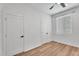 Spare bedroom featuring wood-look floors, two closets, ceiling fan, and a window at 1306 E Fillmore St, Phoenix, AZ 85006