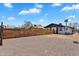 Lovely home exterior featuring a wooden fence, desert landscaping, and a bright blue sky at 1306 E Fillmore St, Phoenix, AZ 85006
