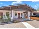 Inviting front exterior of the home with a covered porch, red front door, and desert landscaping at 1306 E Fillmore St, Phoenix, AZ 85006