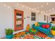 Inviting front porch with colorful decor, a cozy couch, and string lights creating a warm ambiance at 1306 E Fillmore St, Phoenix, AZ 85006