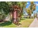 Artistic gallery sign in a lush front yard, surrounded by trees and greenery, adding character to the property at 1306 E Fillmore St, Phoenix, AZ 85006