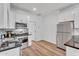 Well-lit kitchen features stainless steel appliances and granite countertops at 1306 E Fillmore St, Phoenix, AZ 85006