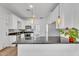 Stylish kitchen featuring white cabinets, stainless steel appliances, and dark countertops at 1306 E Fillmore St, Phoenix, AZ 85006