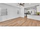 Bright living space featuring wood floors, a ceiling fan, and an open layout into the modern kitchen at 1306 E Fillmore St, Phoenix, AZ 85006