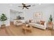 Bright living room featuring modern furnishings, hardwood floors, and an open layout leading to the kitchen at 1306 E Fillmore St, Phoenix, AZ 85006
