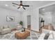 Cozy living room with a ceiling fan, neutral furniture, and a view into the kitchen at 1306 E Fillmore St, Phoenix, AZ 85006