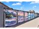 Outdoor mural on a block wall, showcasing colorful and artistic ocean-themed scenes under a blue sky at 1306 E Fillmore St, Phoenix, AZ 85006