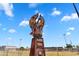 A close-up of the metal Phoenix Rising statue against a bright blue sky on a sunny day at 1306 E Fillmore St, Phoenix, AZ 85006
