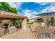 Charming outdoor gazebo with seating, mature landscaping, and a nearby dining area at 13204 W Palo Verde Dr, Litchfield Park, AZ 85340