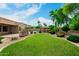 Expansive green backyard featuring a gazebo, mature trees, and privacy landscaping at 13204 W Palo Verde Dr, Litchfield Park, AZ 85340