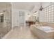 Spacious bathroom featuring a soaking tub, walk-in shower, and dual vanities with granite countertops at 13204 W Palo Verde Dr, Litchfield Park, AZ 85340