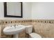 Cozy half-bathroom with elegant pedestal sink and decorative tile work at 13204 W Palo Verde Dr, Litchfield Park, AZ 85340