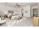 Staged bedroom features a ceiling fan, a large patterned rug, and modern décor at 13204 W Palo Verde Dr, Litchfield Park, AZ 85340
