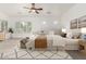 Bright bedroom with large patterned rug, ceiling fan, and modern décor at 13204 W Palo Verde Dr, Litchfield Park, AZ 85340