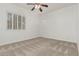 Cozy bedroom with plantation shutters and a ceiling fan at 13204 W Palo Verde Dr, Litchfield Park, AZ 85340