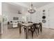 Open dining room with stylish chandelier, decorative wall art, and seamless flow to living area at 13204 W Palo Verde Dr, Litchfield Park, AZ 85340