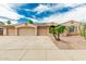 Inviting single-story home featuring a three-car garage and desert landscaping against a bright blue sky at 13204 W Palo Verde Dr, Litchfield Park, AZ 85340