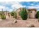 Charming home exterior showcases desert landscaping with cacti and decorative rocks at 13204 W Palo Verde Dr, Litchfield Park, AZ 85340