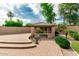 Charming outdoor gazebo with seating, mature landscaping, and surrounding brickwork at 13204 W Palo Verde Dr, Litchfield Park, AZ 85340