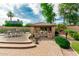 Charming outdoor gazebo with seating, mature landscaping, and a nearby dining area at 13204 W Palo Verde Dr, Litchfield Park, AZ 85340