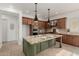 Bright kitchen with a large island, stone countertops, stainless steel appliances, and custom cabinets at 13204 W Palo Verde Dr, Litchfield Park, AZ 85340